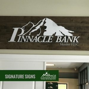 wood, pvc, and brushed aluminum sign