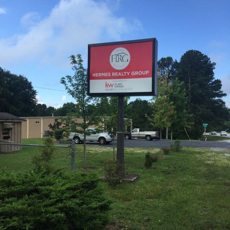 Many pylon signs, like this custom sign for Hermes Realty Group, use light boxes.